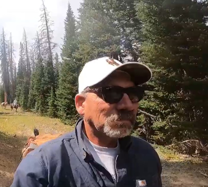 man on horseback in the mountains