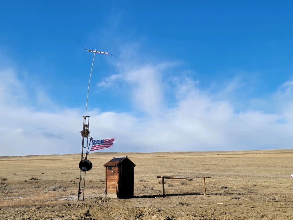 Outhouse, antenna, and American flag