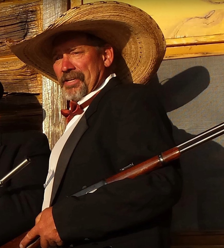 Man in a cowboy hat and black jacket